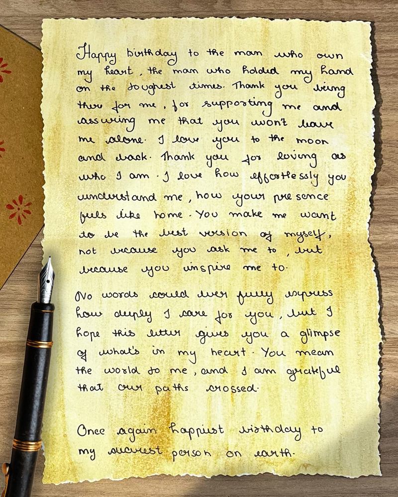 Handwritten birthday letter on aged paper with a fountain pen
