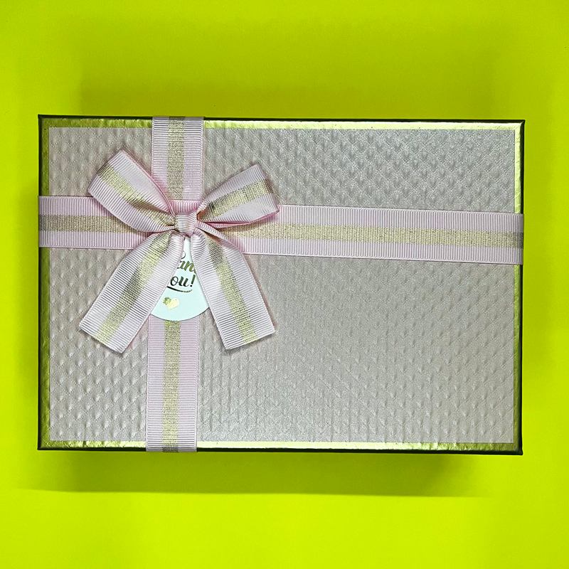 Pastel pink gift box tied with a satin ribbon, ready for a kids' birthday surprise
