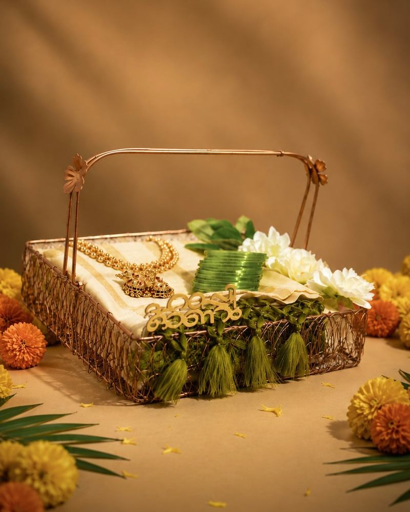 Onam gift hamper in a cane basket with a kasavu mundu and white flowers, made in Kochi