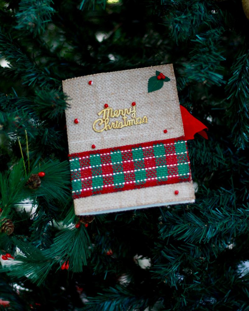 Handmade Christmas card with a tartan band in a decorated Christmas tree